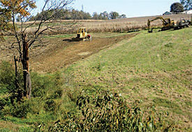 Contractors prepare to install a pond to help control excessive runoff during
storm events.