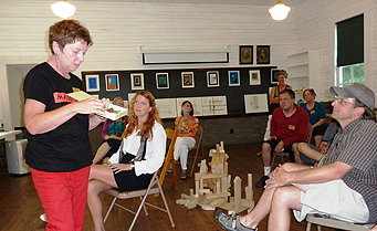 Andrew Phillips (far right), a faculty member at the 
Charter High School for Architecture and Design, listens to a 
participant in Fallingwater’s summer residency program.